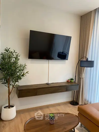 Modern living room with wall-mounted TV and stylish decor