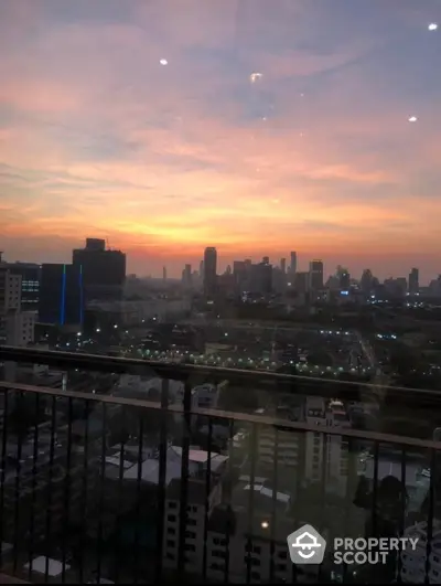 Stunning city skyline view from a high-rise balcony at sunset, perfect for urban living enthusiasts.