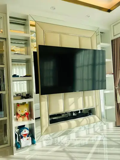 Modern living room with sleek TV setup and stylish shelving
