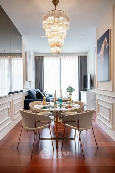 Elegant dining area with chandelier and modern decor in a luxurious apartment.