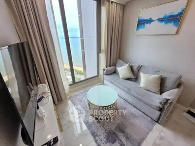 Luxurious living room with stunning ocean view, elegant decor, and modern furnishings.