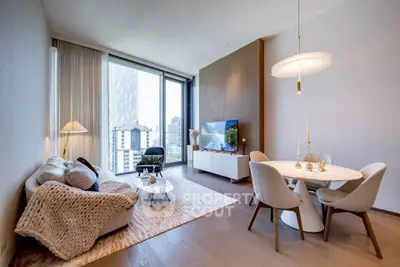 Luxurious modern living room with city view, elegant decor, and cozy ambiance.