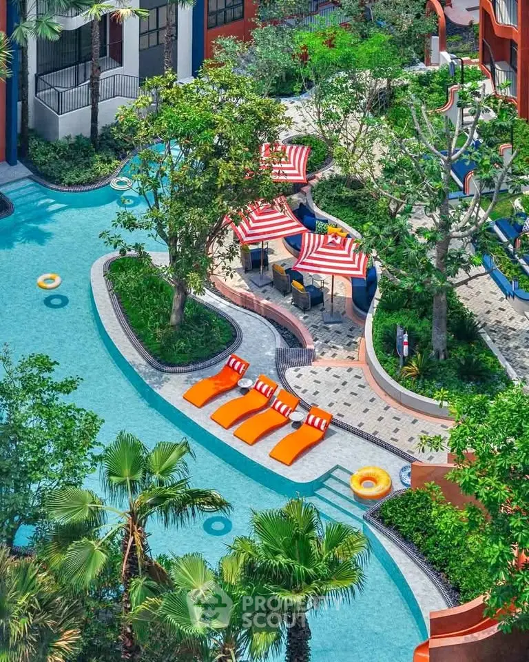 Luxurious resort-style pool with vibrant loungers and lush greenery, perfect for relaxation and leisure.