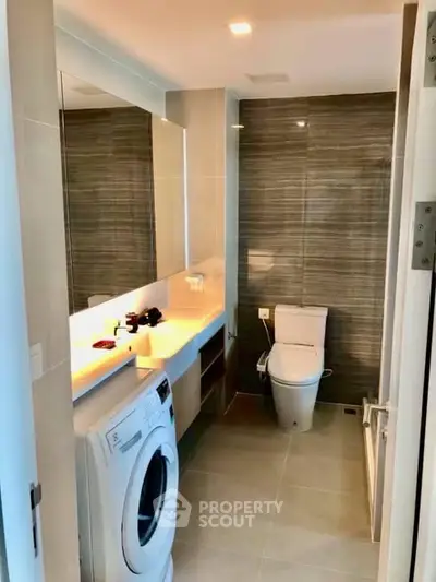 Modern bathroom with washing machine and sleek design
