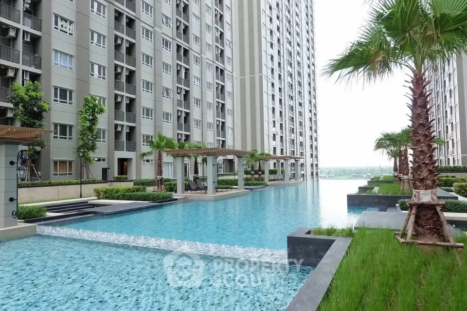 Luxurious apartment complex with stunning infinity pool and lush landscaping.