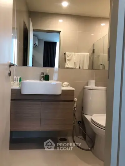 Modern bathroom with sleek fixtures and glass shower enclosure