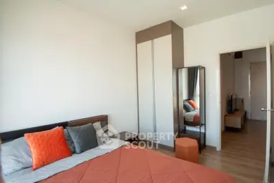 Modern bedroom with a large bed, mirrored wardrobe, and warm wooden flooring, offering a cozy and inviting atmosphere.