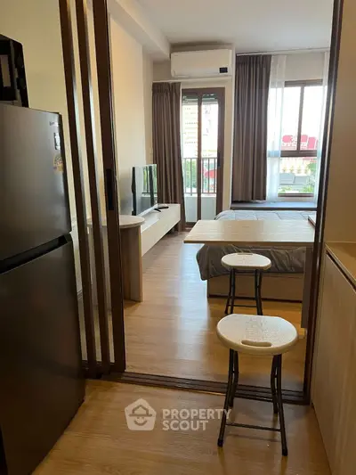 Modern studio apartment with open layout and balcony view