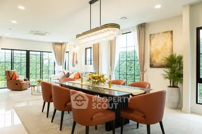 Luxurious open-plan living and dining area with elegant chandelier and modern decor.