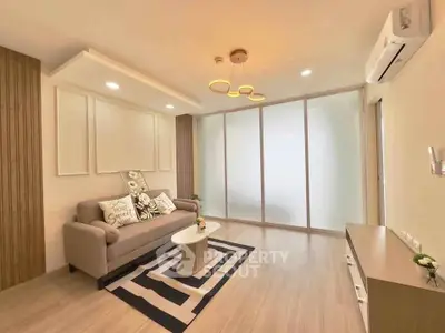 Modern living room with stylish decor and cozy ambiance, featuring a comfortable sofa and elegant lighting.