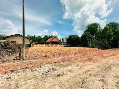 Expansive land plot with potential for development, featuring a rural setting and clear skies.