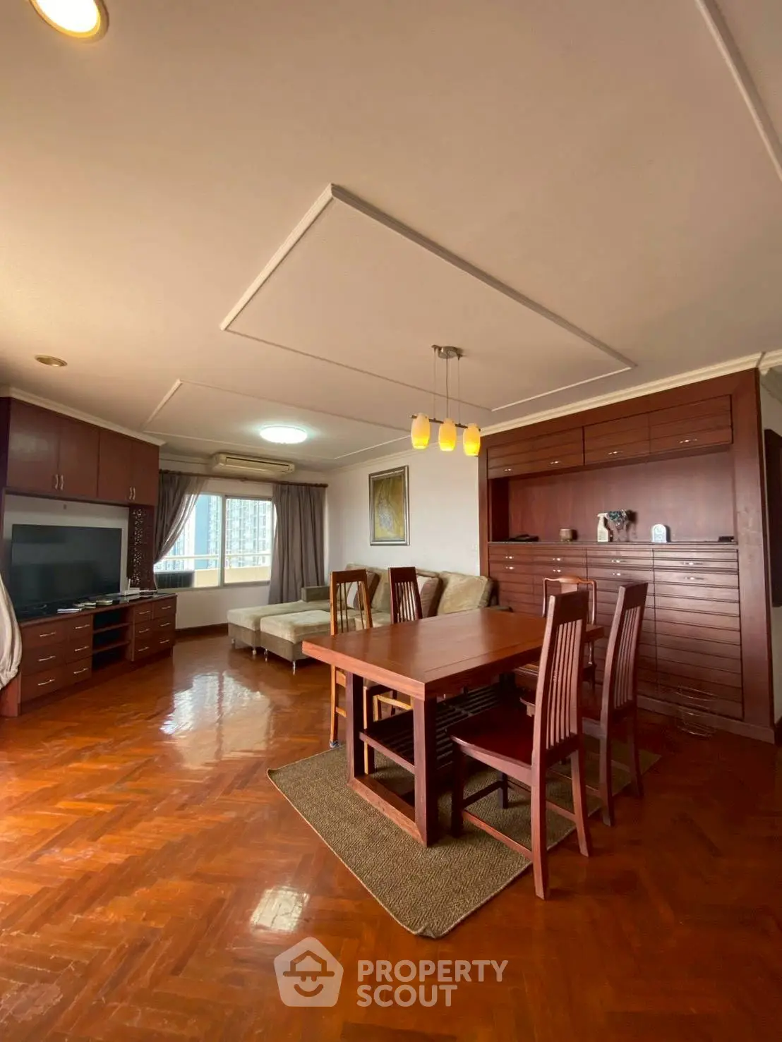 Spacious living room with elegant wooden flooring and modern furniture