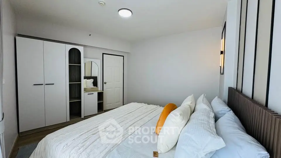 Modern bedroom with stylish decor and ample natural light