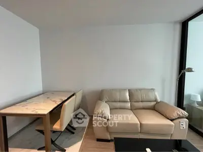 Modern living room with beige sofa and marble dining table, perfect for cozy gatherings.