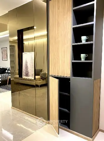 Modern living room with sleek mirrored cabinets and stylish decor