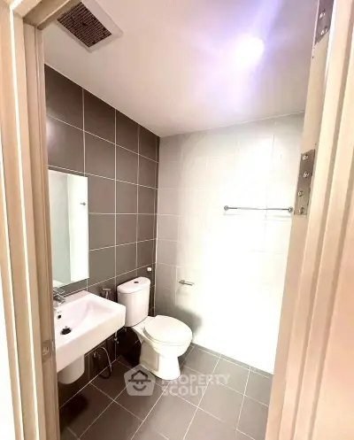 Modern bathroom with sleek tiles and contemporary fixtures.