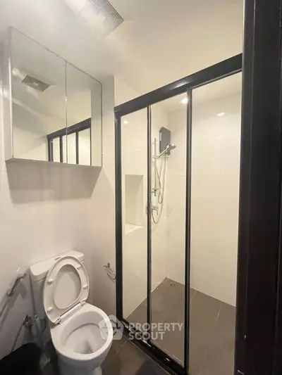 Modern bathroom with glass shower enclosure and sleek fixtures