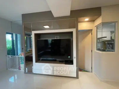 Modern living room with sleek TV unit and glossy flooring