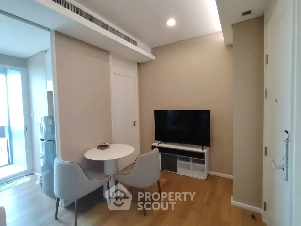 Modern living room with sleek furniture and wooden flooring in a cozy apartment.