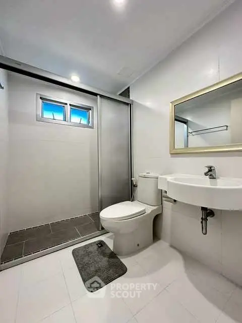 Modern bathroom with sleek shower and minimalist design.
