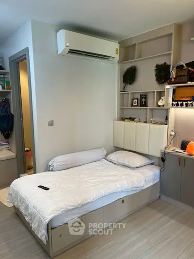 Modern bedroom with built-in storage and air conditioning