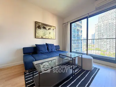 Modern living room with stylish furniture and city view from large windows.