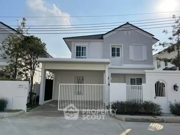 Charming two-story house with modern design and gated driveway in a serene neighborhood.