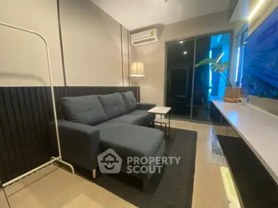Modern living room with sleek furniture and ambient lighting, perfect for relaxation and entertainment.