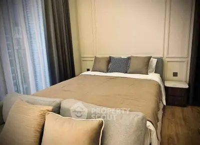 Cozy bedroom with elegant decor and soft lighting, featuring a comfortable bed and stylish cushions.