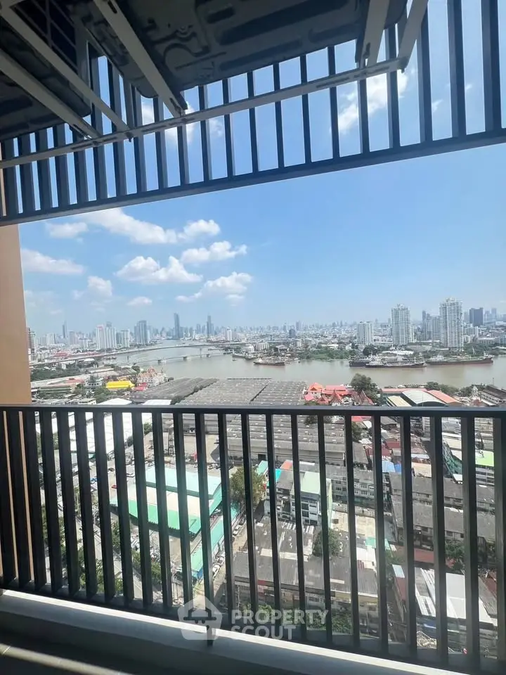 Stunning cityscape view from high-rise balcony overlooking river and skyline.