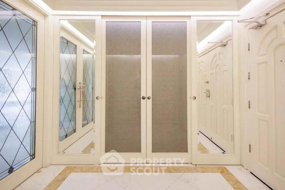 Elegant building entrance with mirrored doors and stylish design