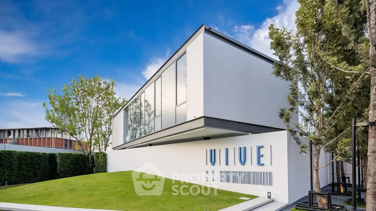 Modern architectural masterpiece with sleek design and lush green lawn, perfect for luxury living.