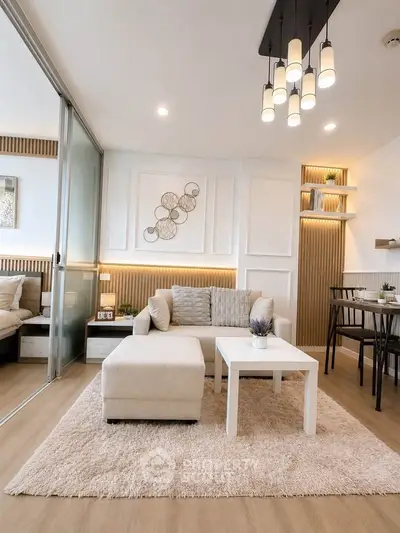 Modern living room with cozy seating and elegant lighting in a stylish apartment.