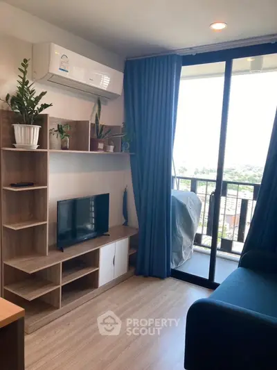 Modern living room with balcony view, stylish shelving, and cozy seating area.