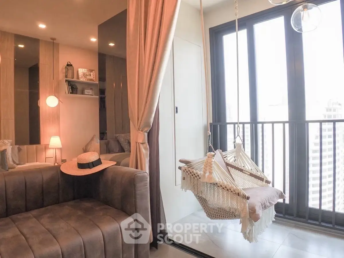 Chic modern living room with cozy hammock and floor-to-ceiling windows offering stunning city views.
