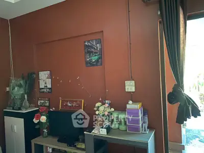 Cozy living room with warm brown walls and stylish decor