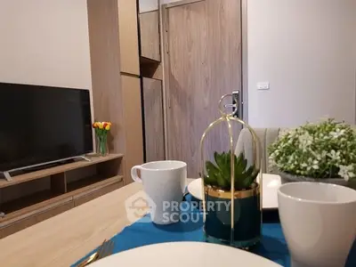 Modern living room with stylish decor and flat-screen TV, perfect for relaxation.