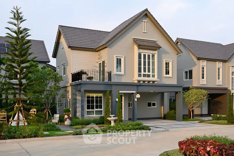 Charming two-story suburban house with manicured garden and modern architecture.