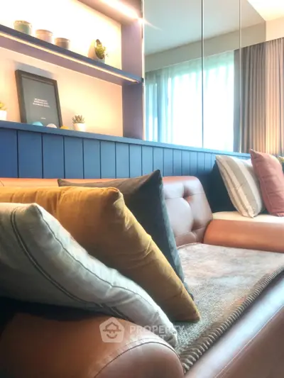 Stylish modern living room with cozy leather sofa and decorative pillows, perfect for relaxation.