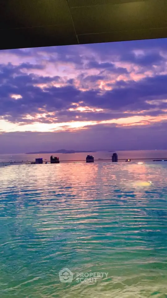Stunning ocean view from a high-rise building at sunset, perfect for luxury living.