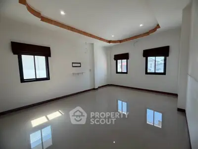 Spacious empty room with glossy tiled floor and modern ceiling design
