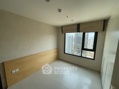 Spacious bedroom with city view in modern high-rise apartment