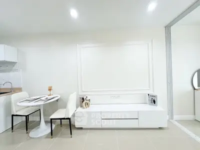 Modern minimalist living room with sleek white furniture and dining area