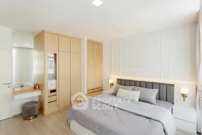 Modern bedroom with stylish decor and ample natural light