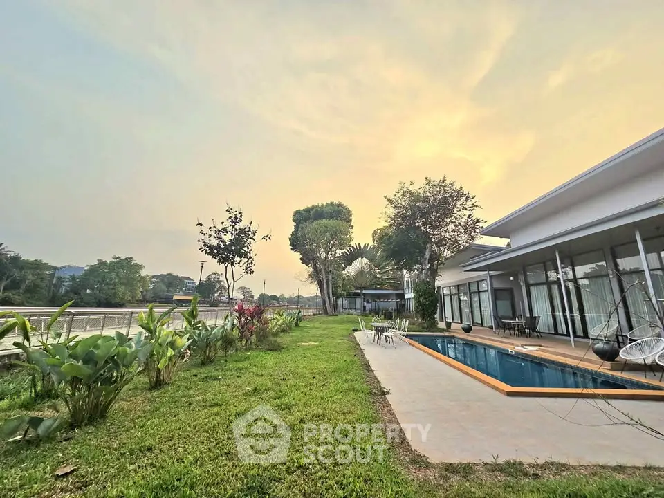 Luxurious modern home with private pool and lush garden at sunset, perfect for serene living.