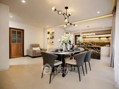 Luxurious open-plan living and dining area with modern decor and elegant lighting.