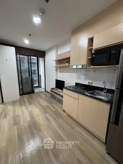 Modern kitchen with sleek cabinetry and open layout in a stylish apartment.