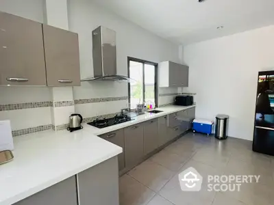 Modern kitchen with sleek cabinetry and gas stove in a spacious layout