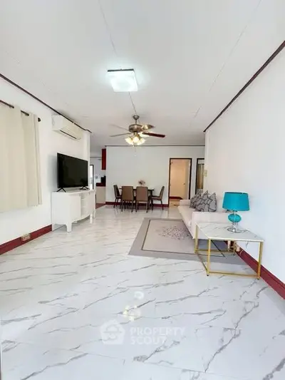 Spacious living room with modern decor and elegant marble flooring