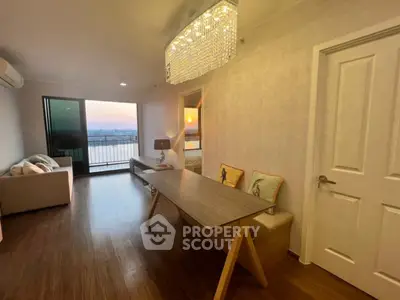 Modern living room with stunning sunset view and elegant chandelier
